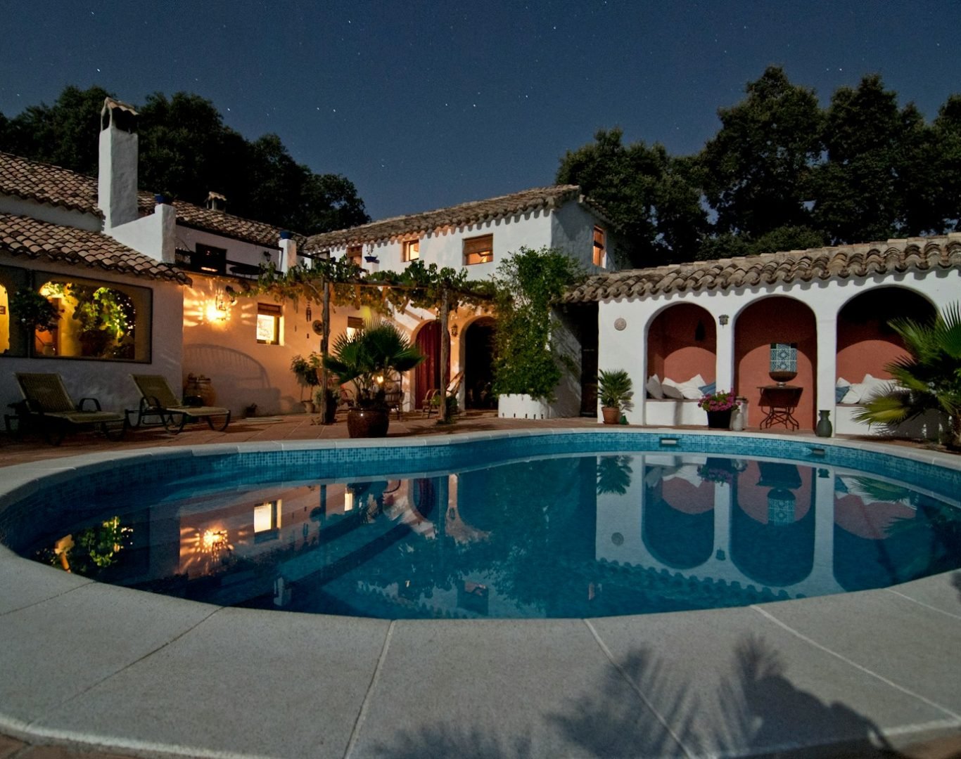 white concrete house surrounded by trees
